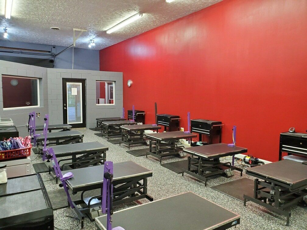 A room filled with tables and chairs with red walls.