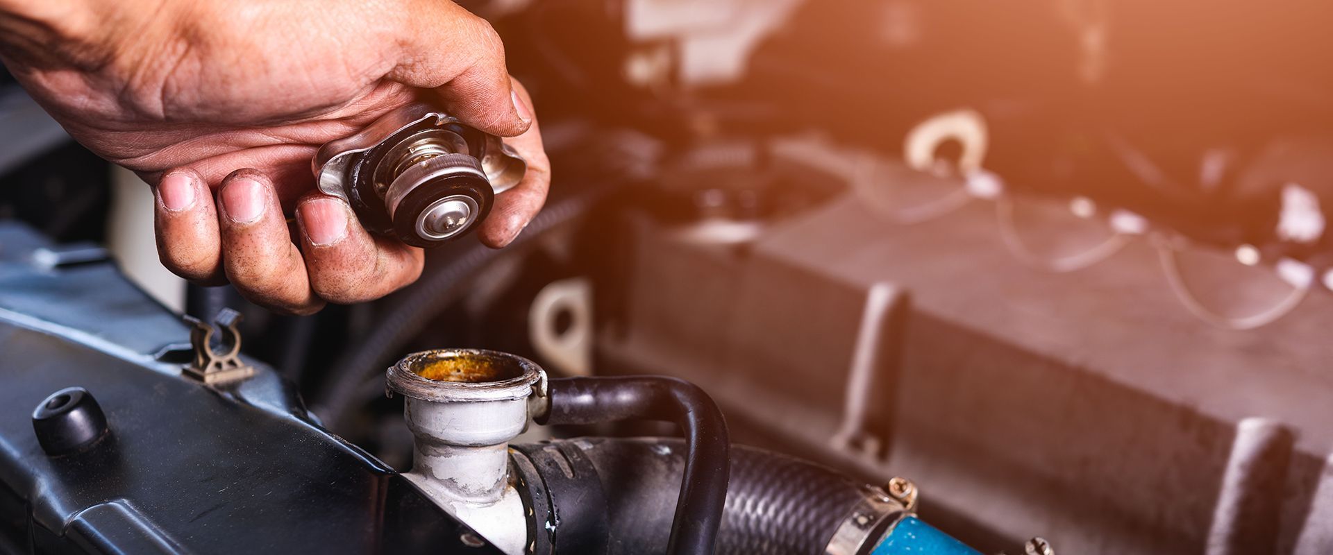 Man performing a fluid check on a car