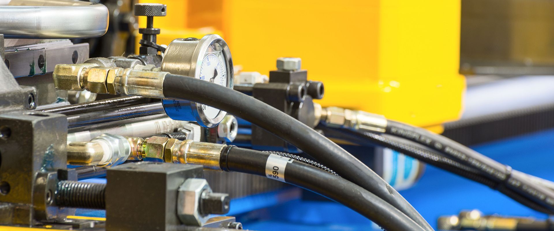 A close up of a machine with hydraulic hoses attached to it.