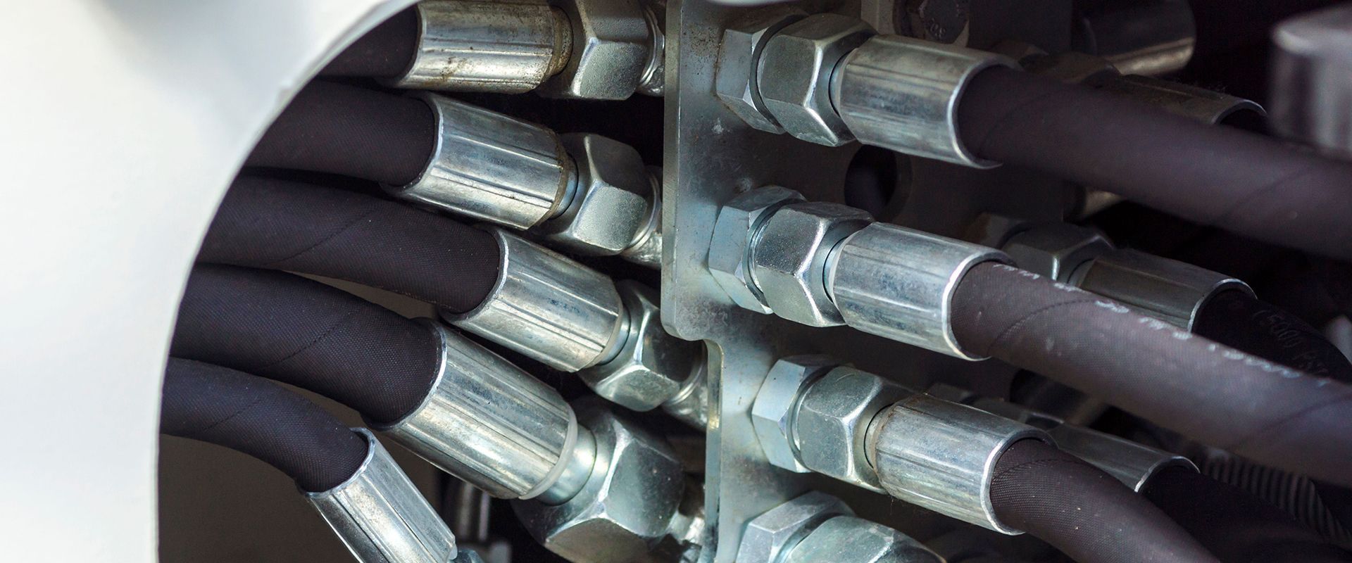 A bunch of hydraulic hoses are connected to a machine.