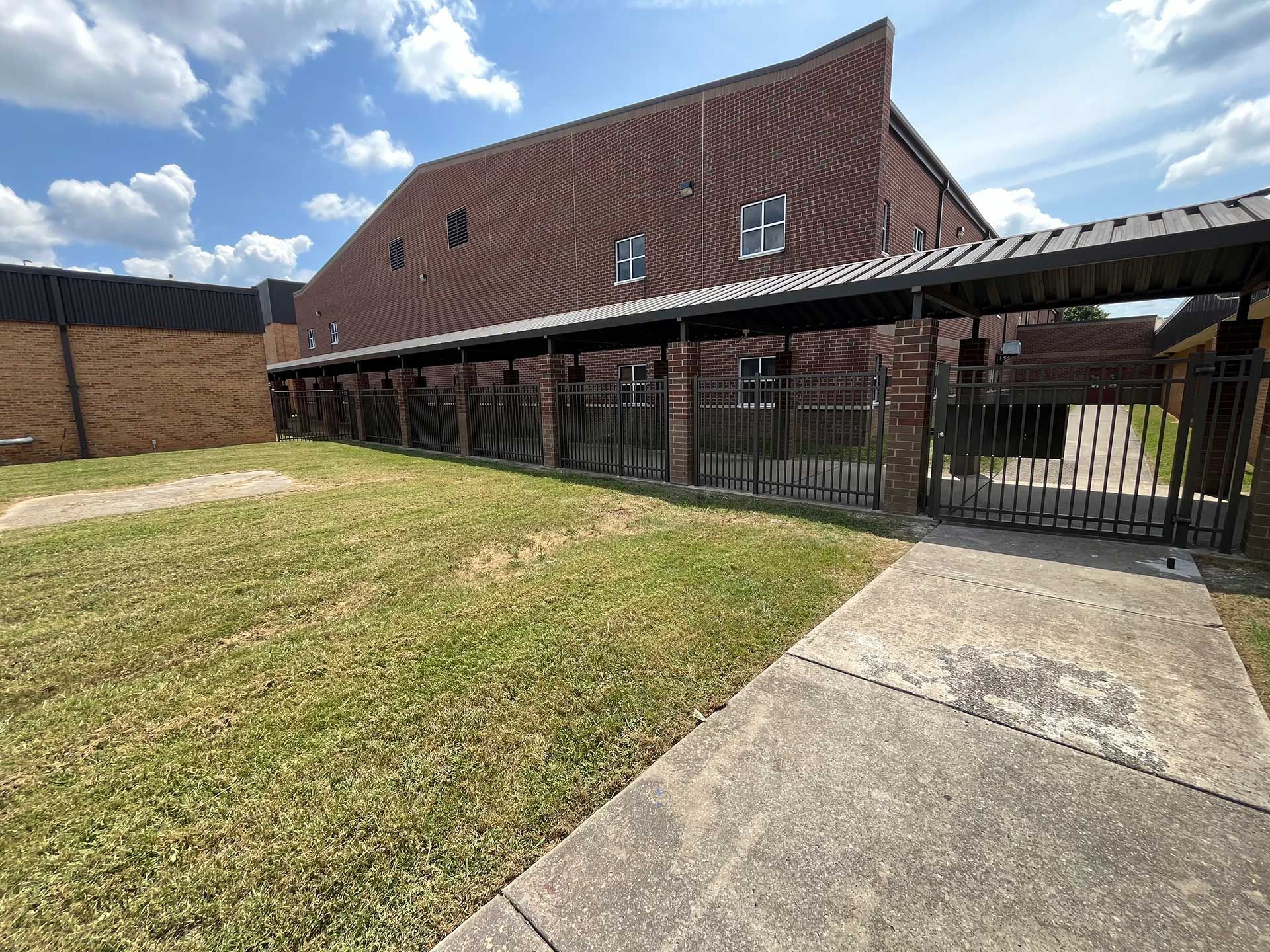 A brick building with a covered walkway leading to it