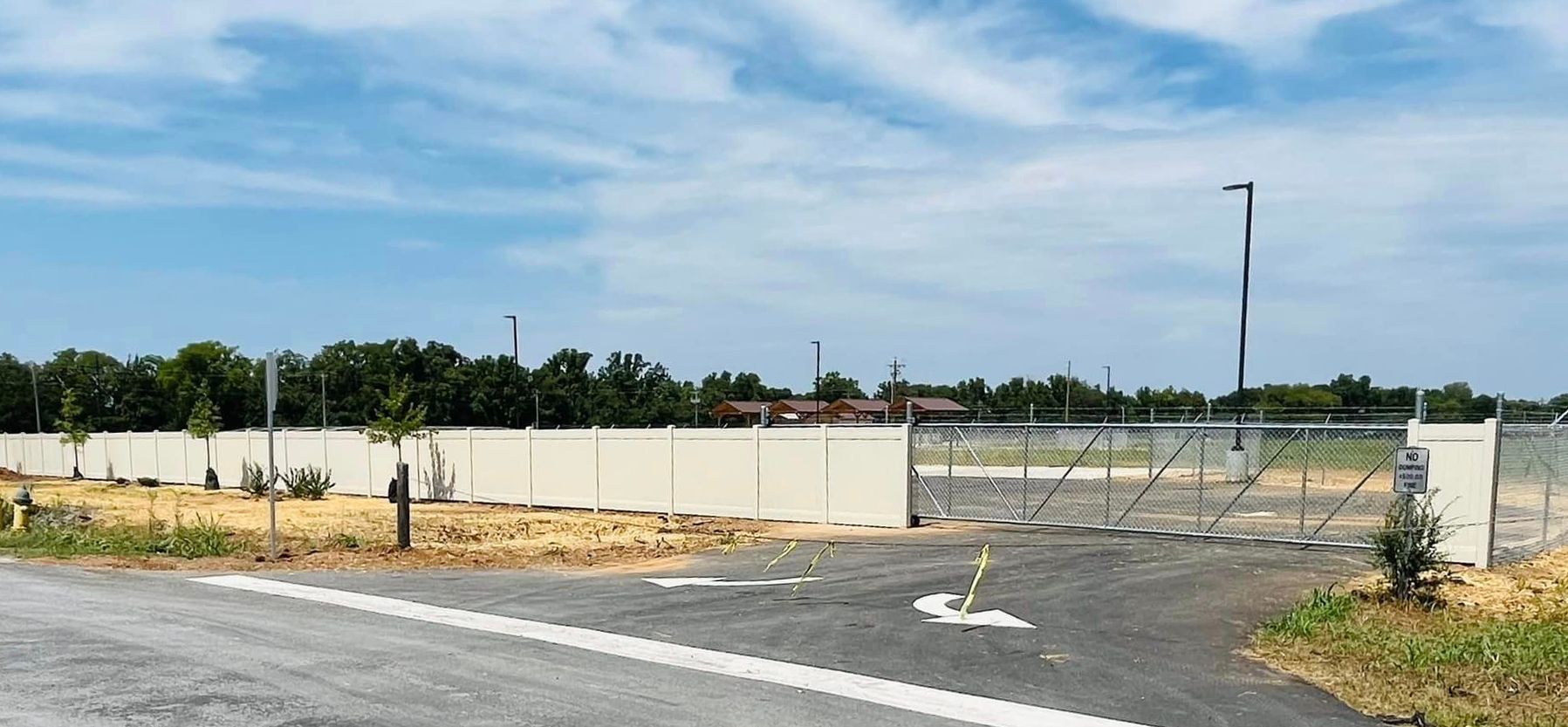 a fenced in area with a gate in the middle of it