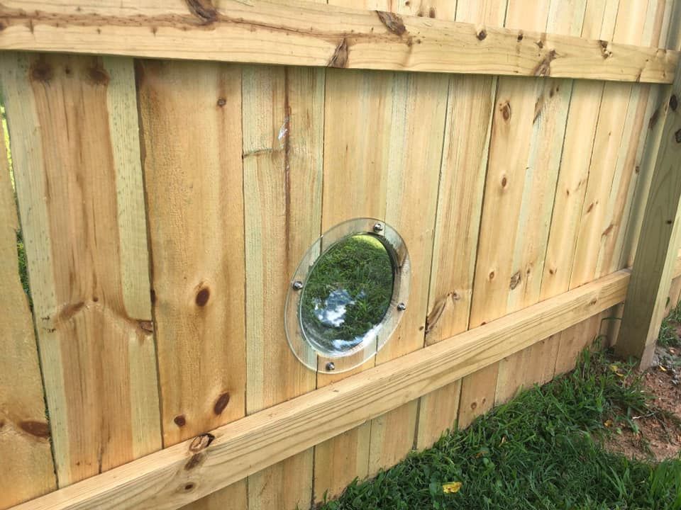 a wooden fence with a hole in the middle of it