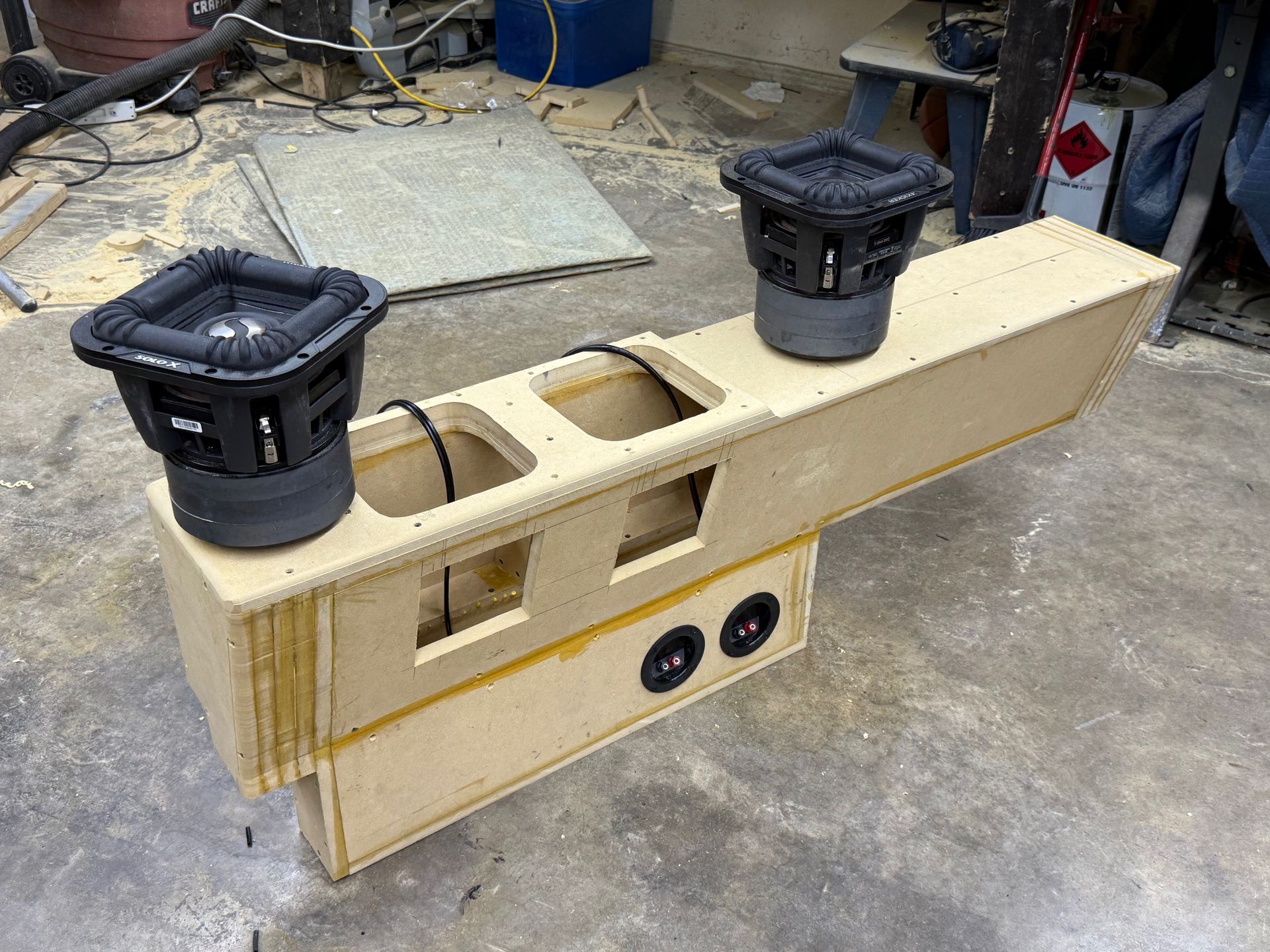Custom car audio subwoofer enclosure with two subwoofers mounted on top and two speakers on the front.