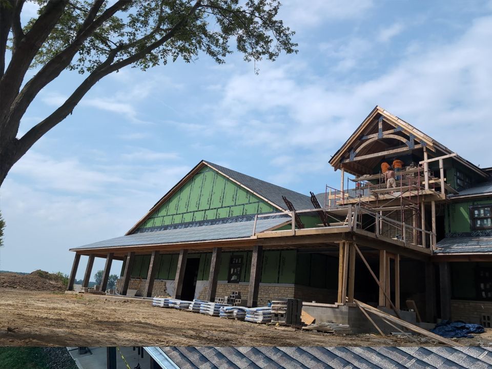 Building under construction with a porch and second-story balcony. Workers visible on balcony. Blue sky.