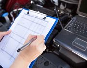 Mechanic taking down notes