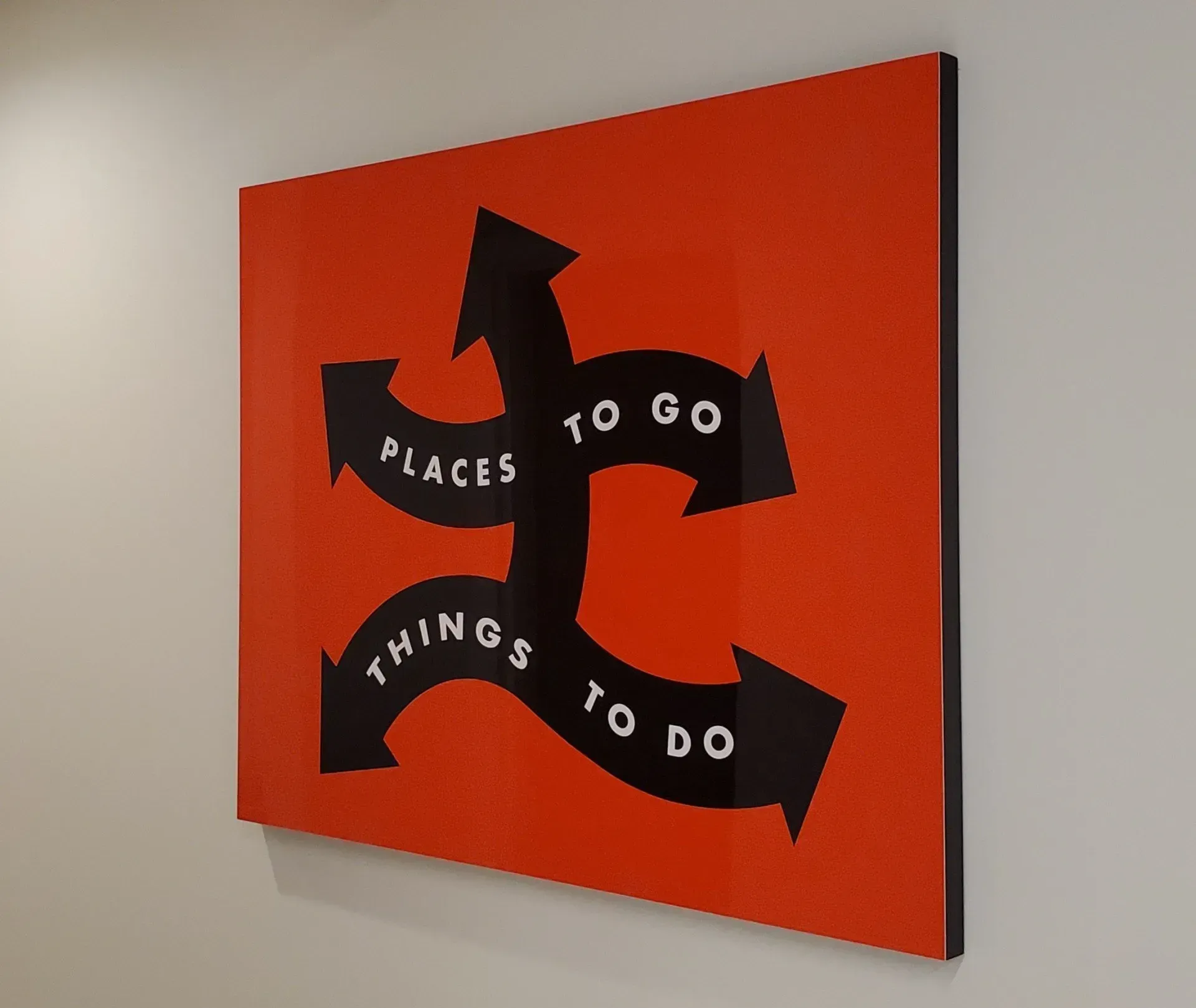 Red sign with black arrows and text 