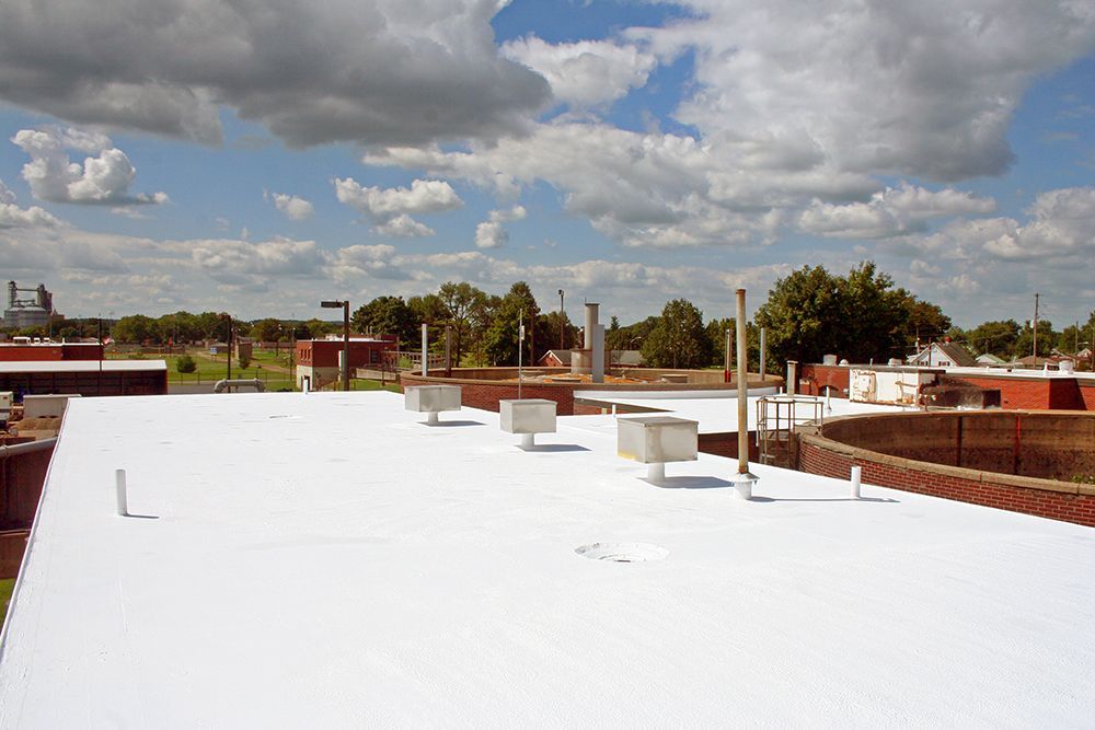 A white roof with a blue sky and clouds in the background