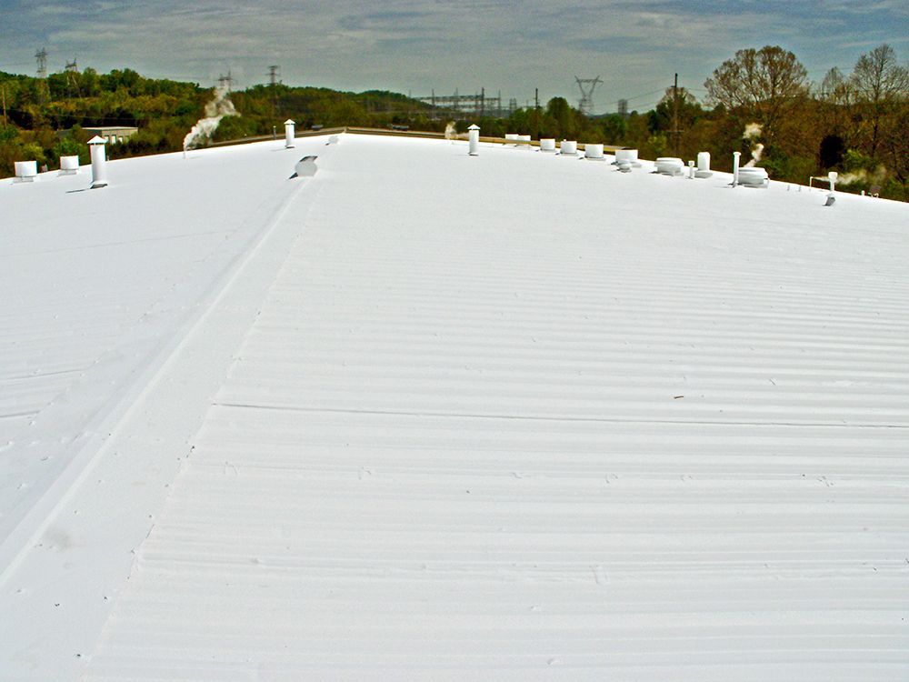 A large white roof with a blue sky in the background.
