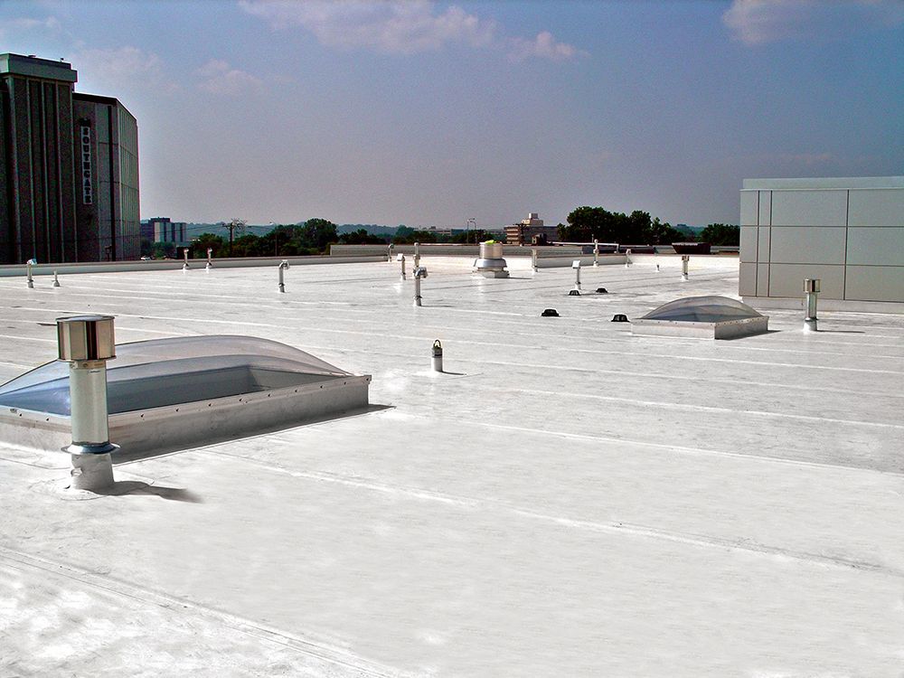 The roof of a building has been painted white.