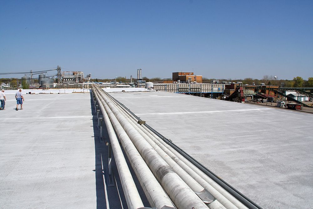 A rooftop with a lot of pipes on it