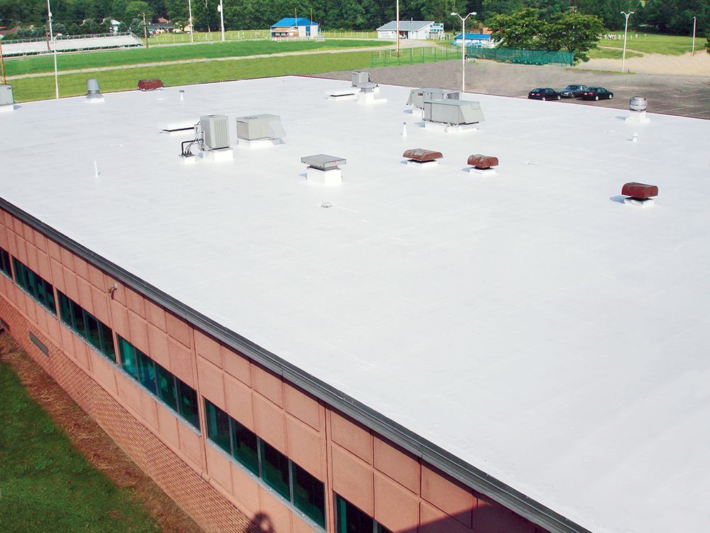 An aerial view of a building with a white roof
