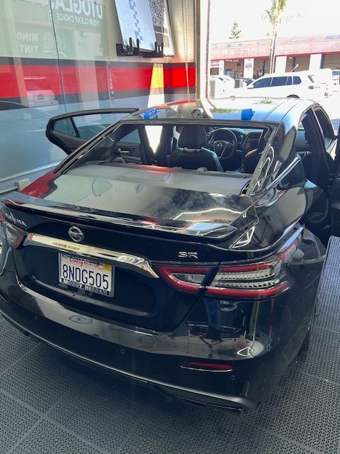 A black car with a license plate that says end6505