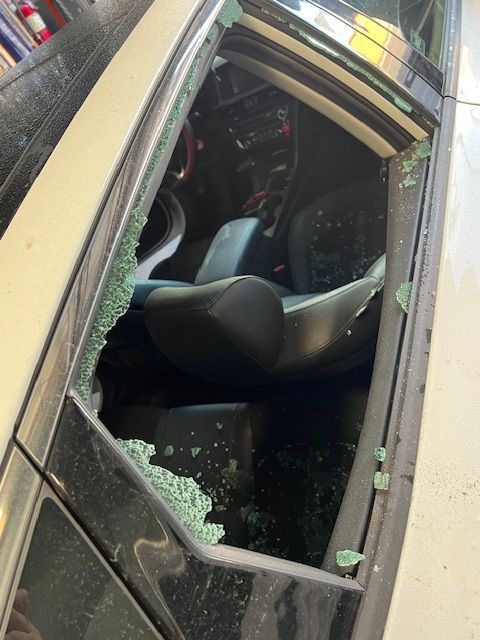 The inside of a car with a broken window