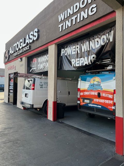 A building with a sign that says window tinting and power window repair