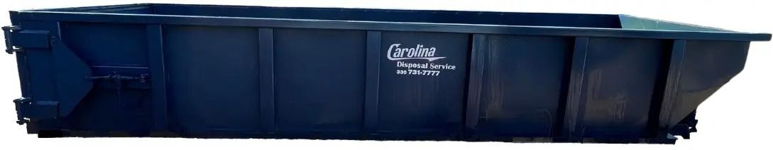 A large blue dumpster is sitting on top of a white surface.