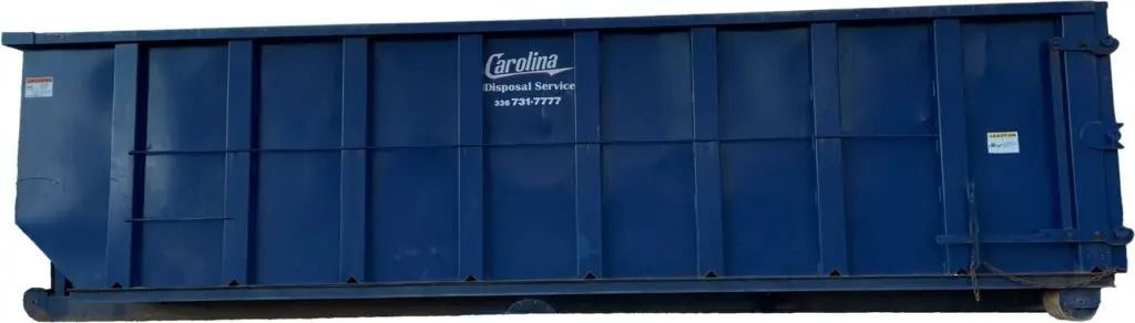 A large blue dumpster is sitting on a white surface.
