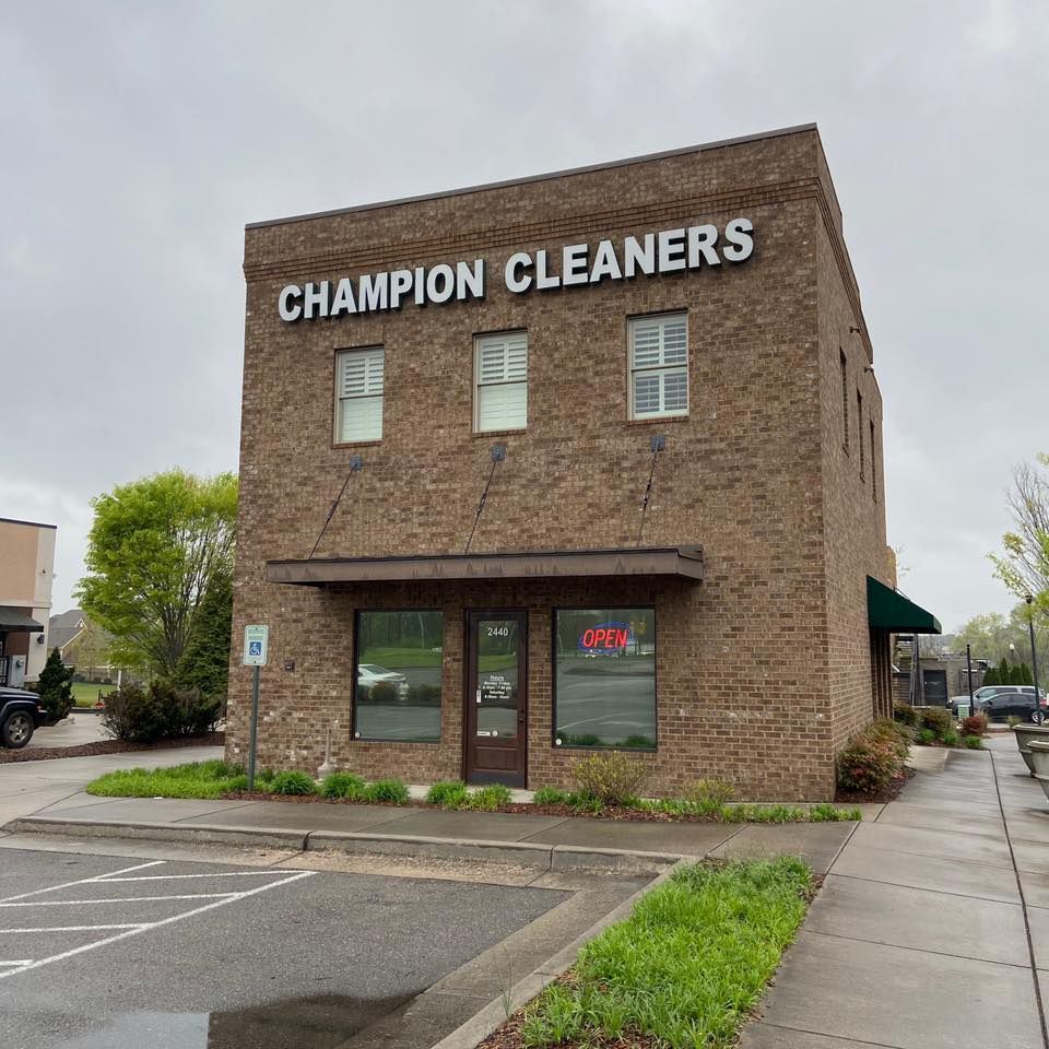 Champion Cleaners, two-story brick building with awning and 