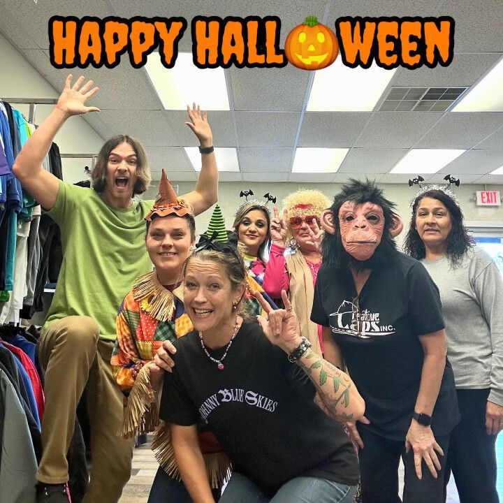 A group of people posing for a picture with the caption happy halloween