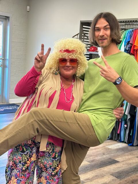 A man is holding a woman in a wig in his arms