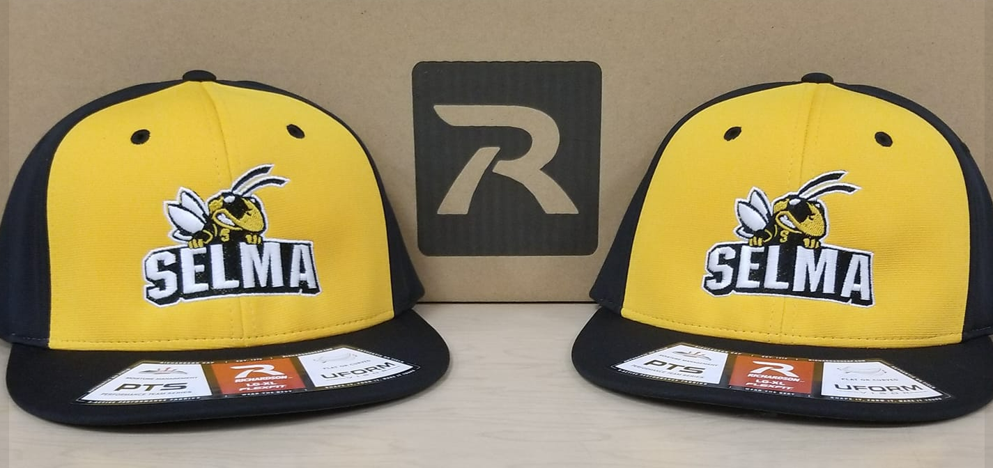 Two yellow and black selma hats are sitting next to each other.