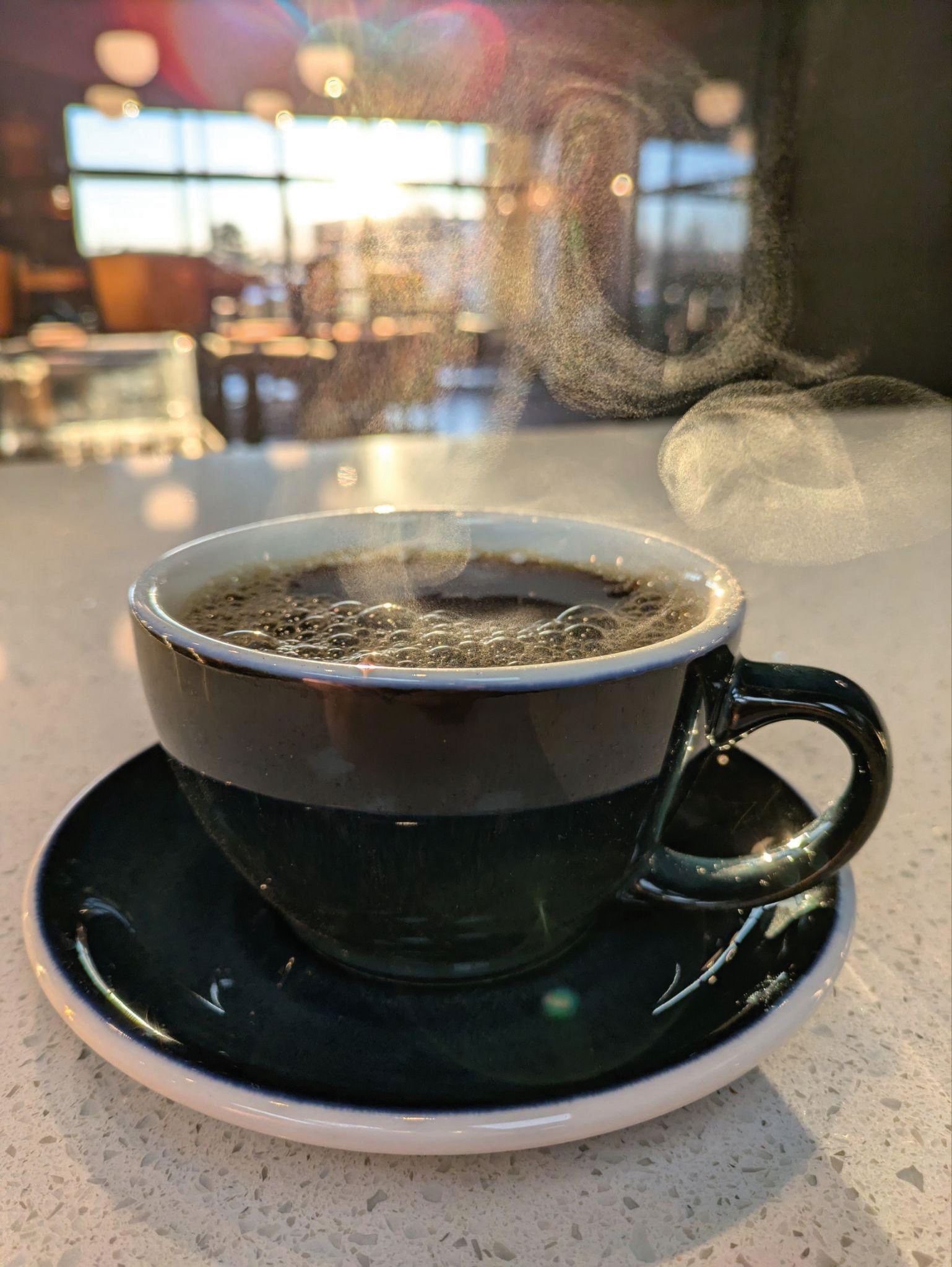 Steaming mug of coffee at Aroma Coffee House