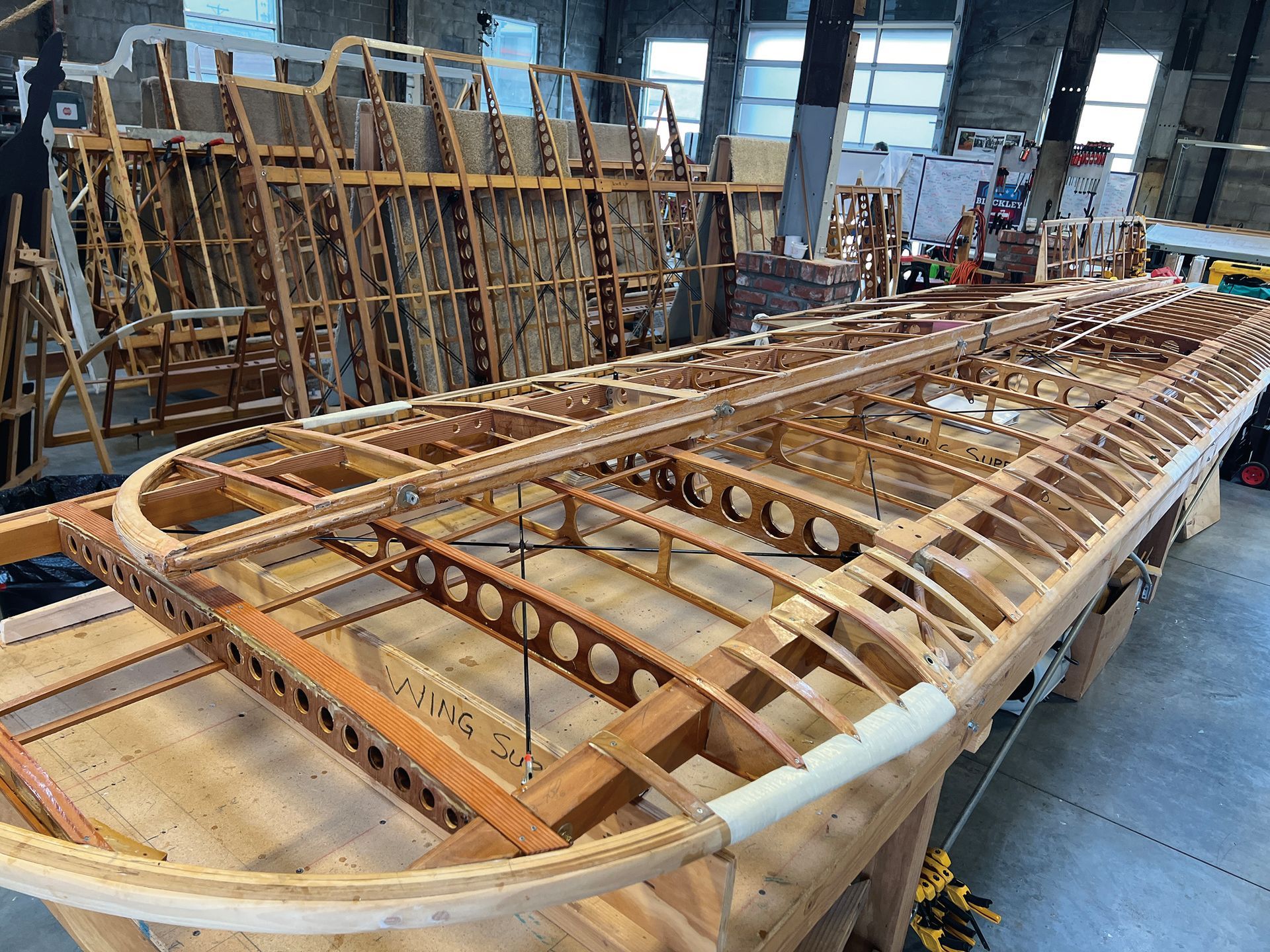 The wing of a historical DH-4 aircraft being rebuilt by volunteers in Wichita, KS.