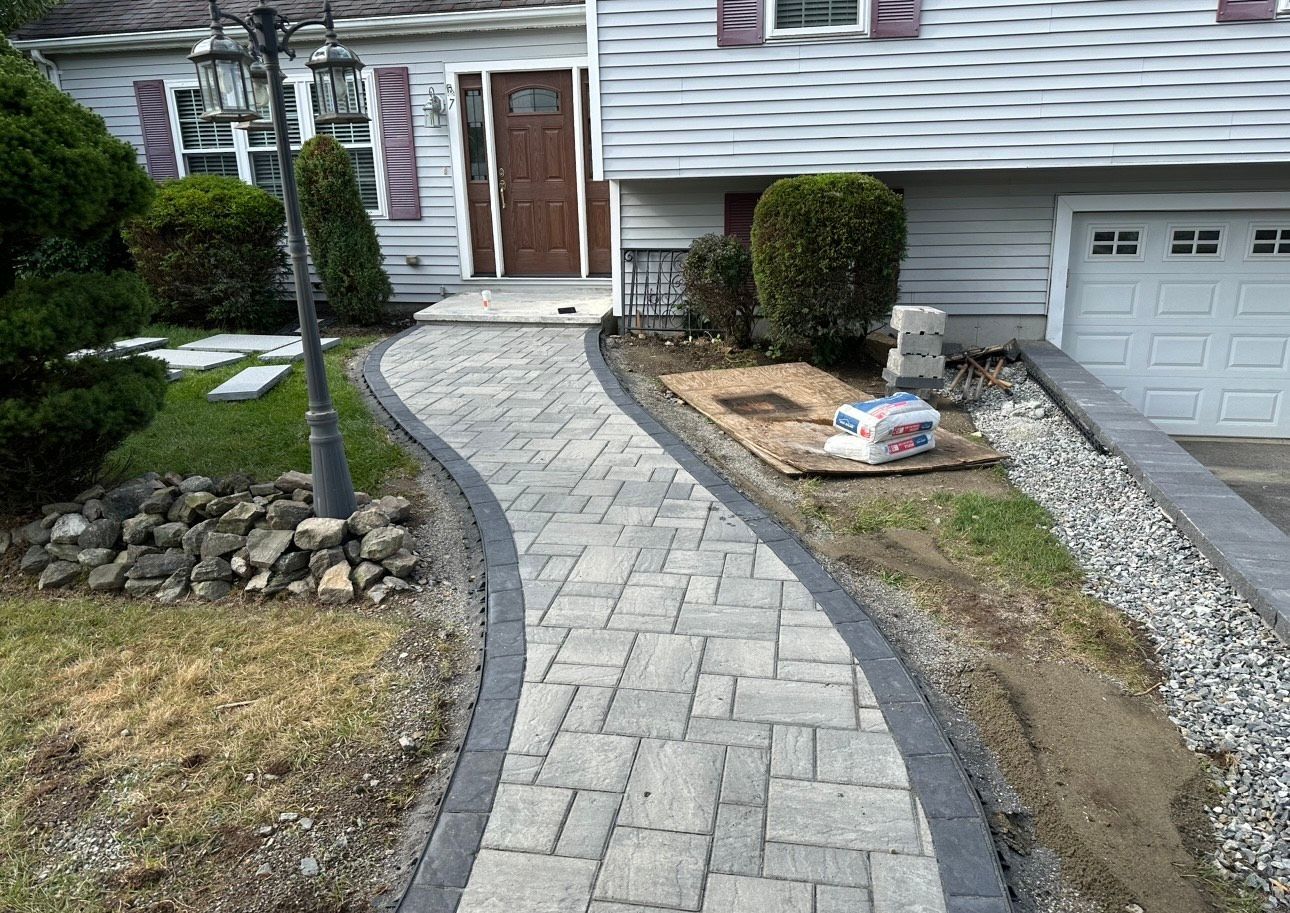 A walkway is being built in front of a house.
