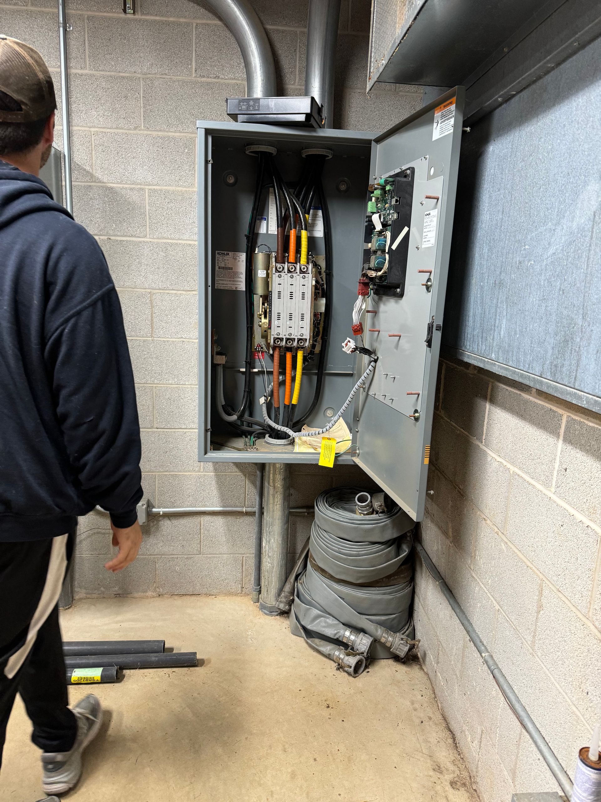 A man is standing in front of an electrical box.