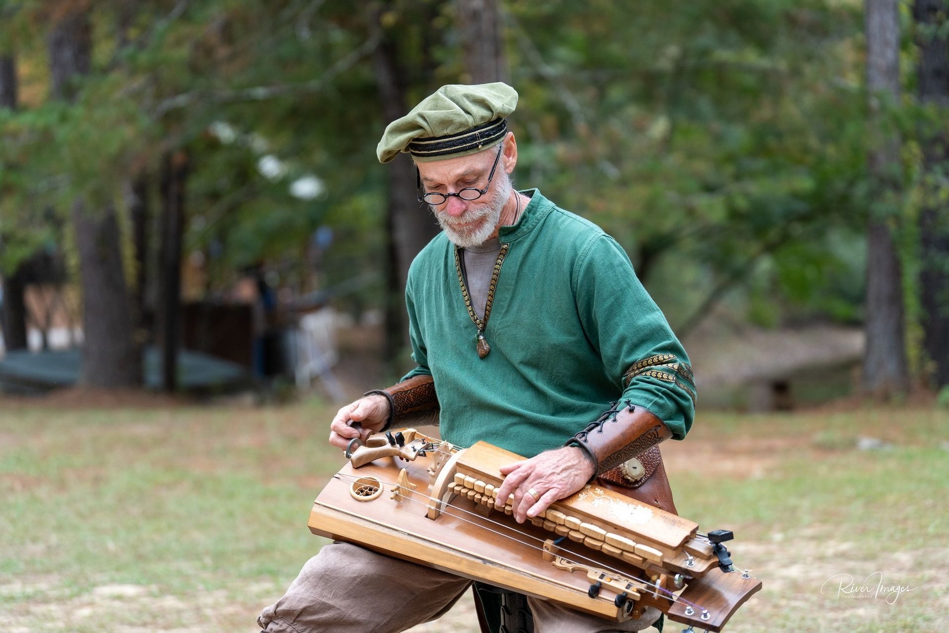 Two people dressed as pirates perform music: woman plays flute, man plays guitar. They are in an outdoor setting.