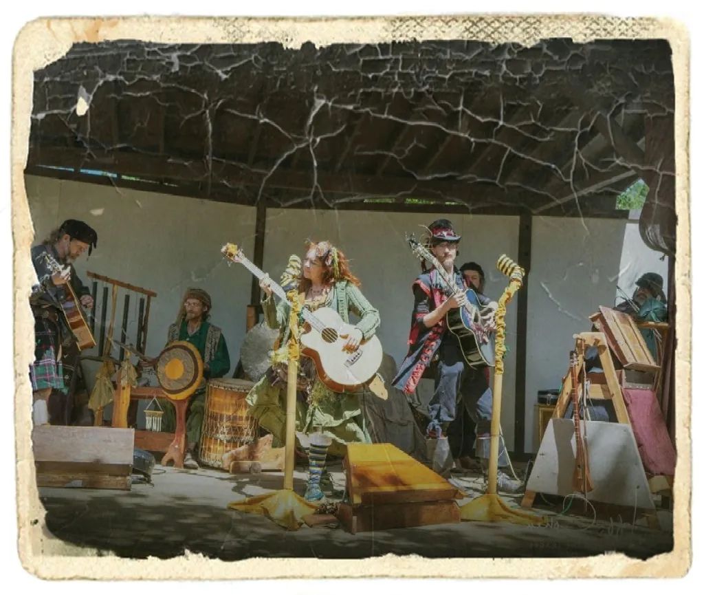 Band performs on an indoor stage under a cracked ceiling, with guitars, drums, and microphones.