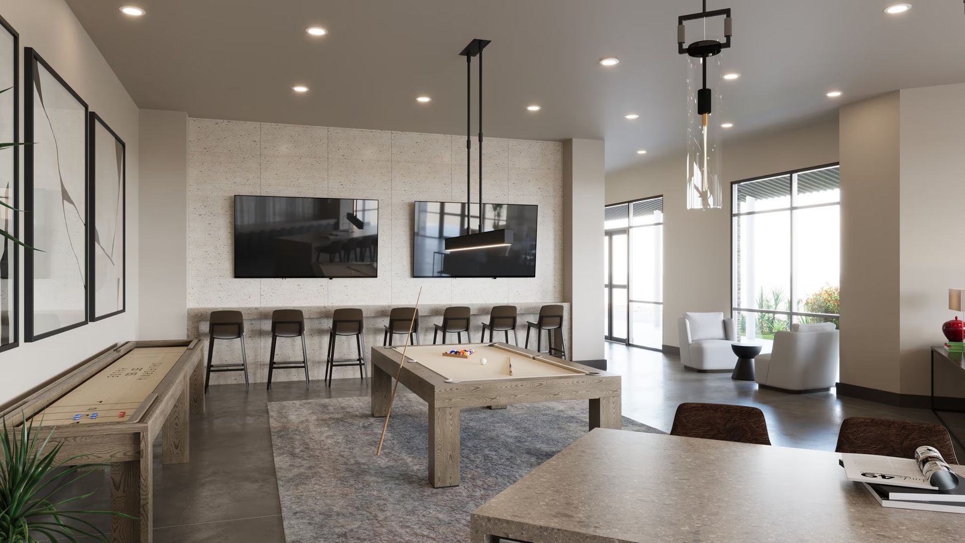 Modern open-plan living room and dining area with neutral decor, wall-mounted TV, bar stools, and large windows.