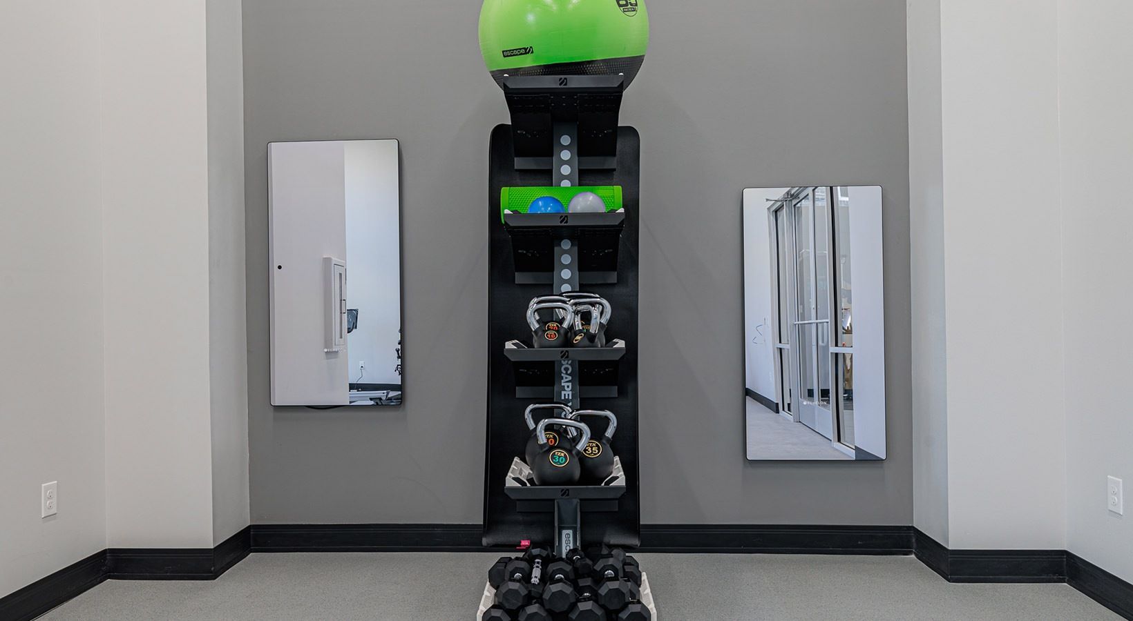 Robot display in a hallway with mirrored wall panels and gray flooring