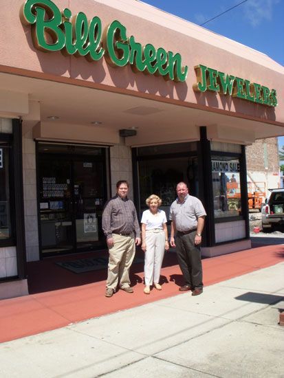 Three people stand in front of 