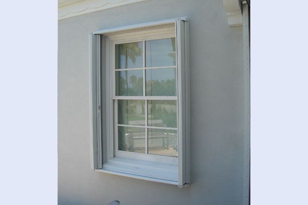 Window with white frame on gray exterior wall.