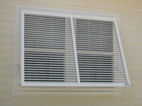 White window with blinds, one side open. Beige siding.