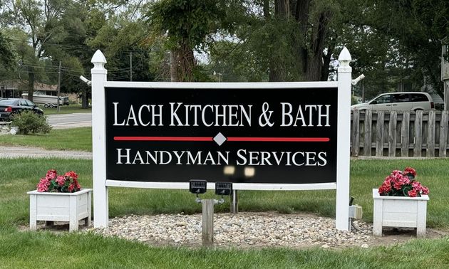 A black, white, and red sign reading 