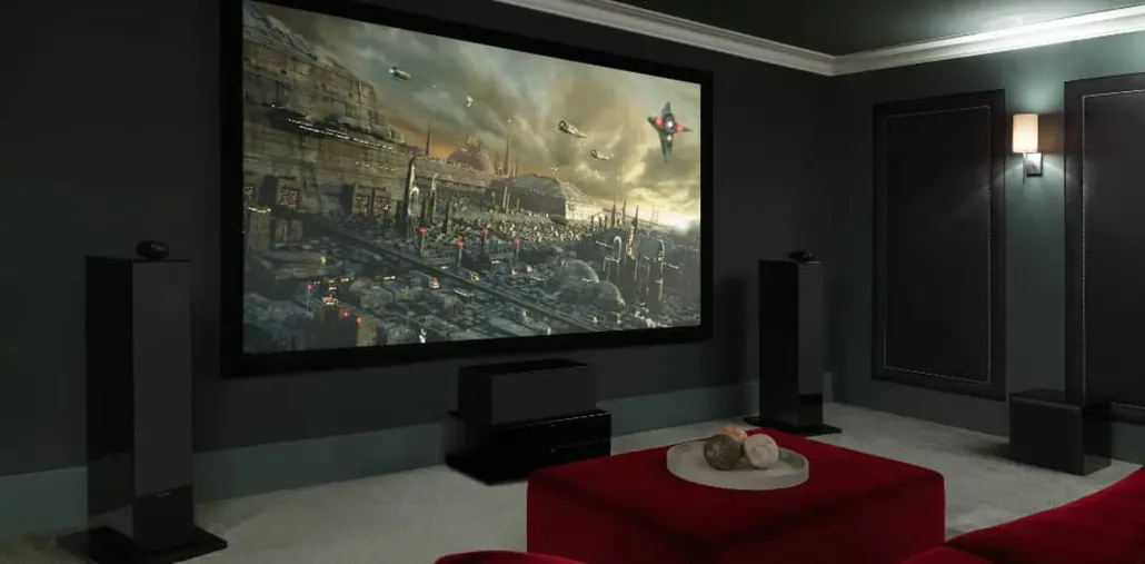 Modern home theater with a large wall screen, black speakers, and a red sectional sofa in a dark room