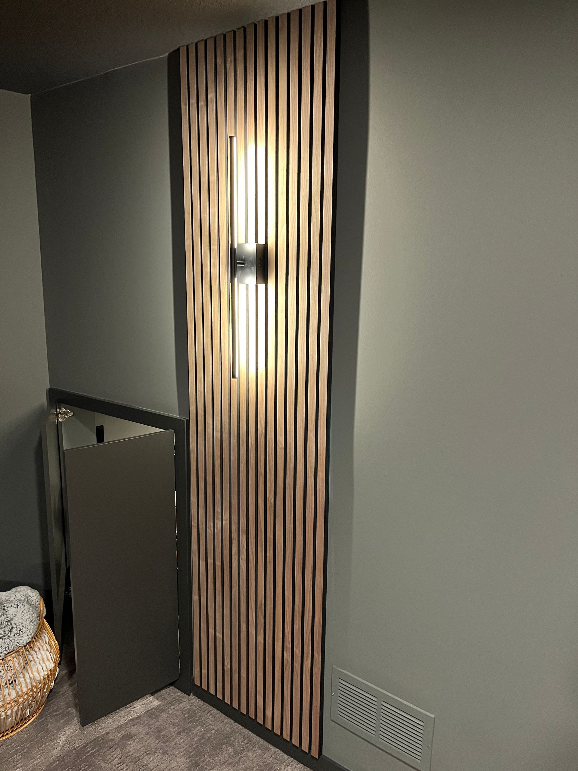 A room with a wooden wall and a light on it.