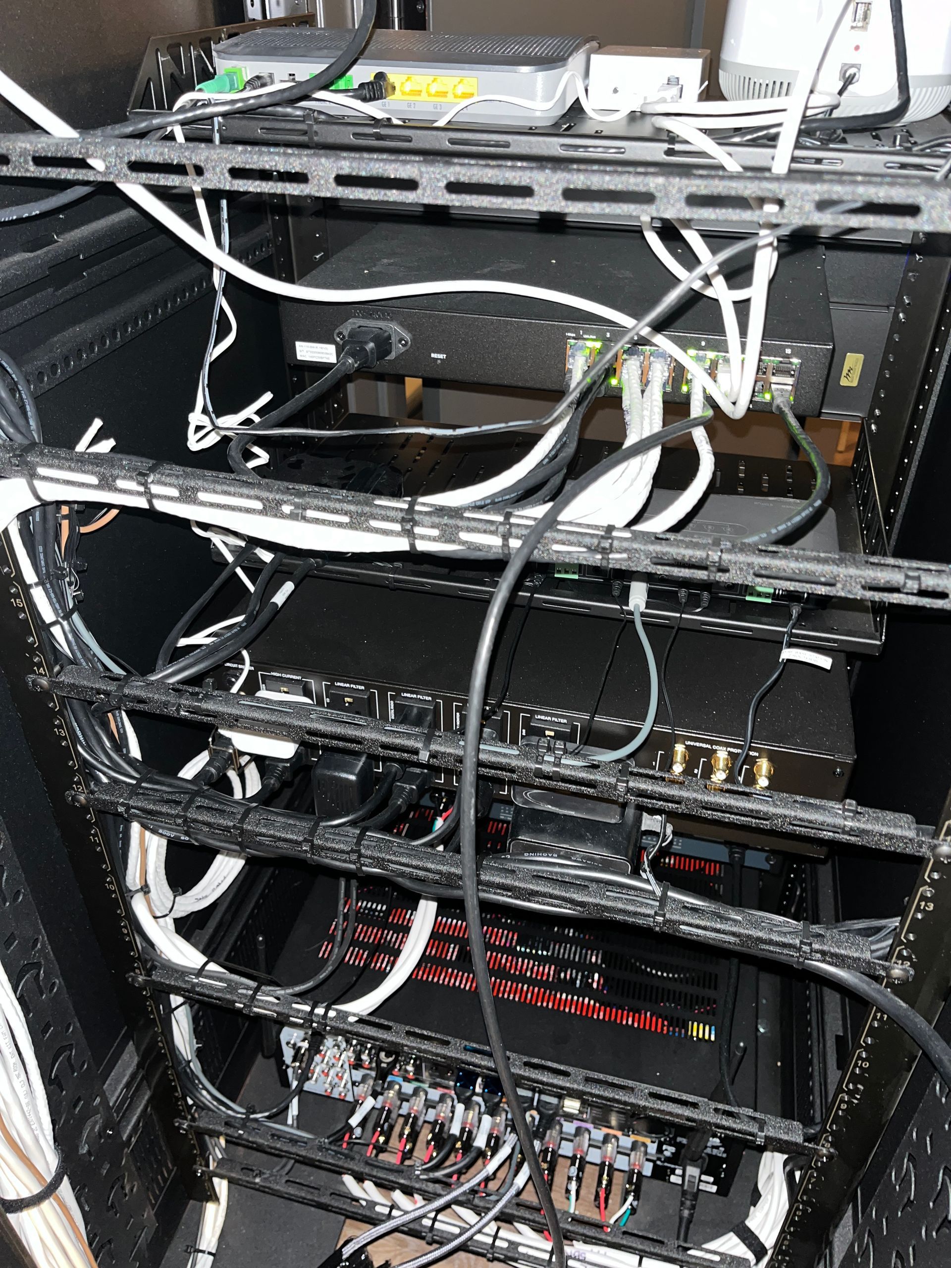 A server rack with a lot of wires coming out of it