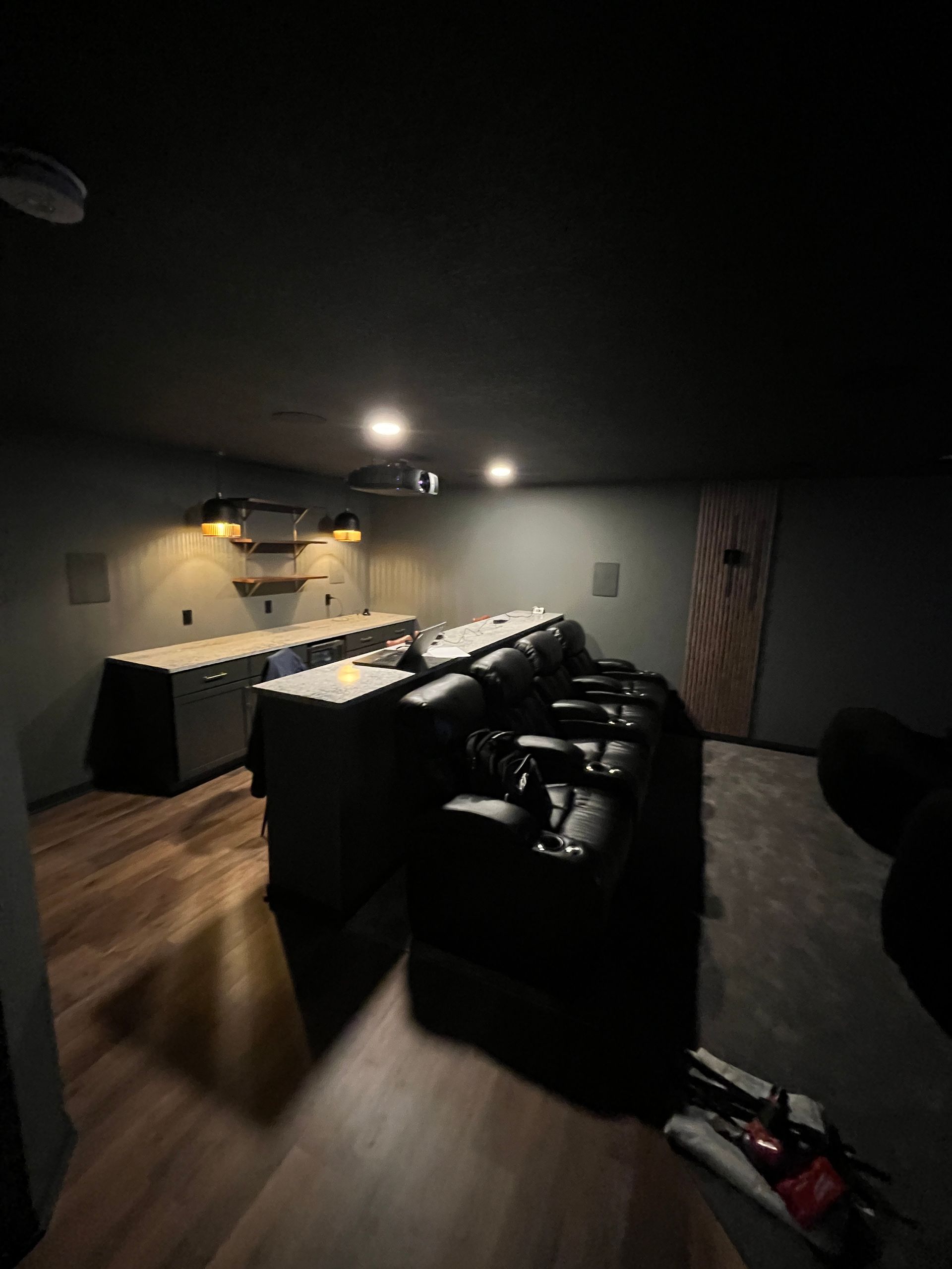 A dark room with a lot of furniture and a vacuum cleaner.
