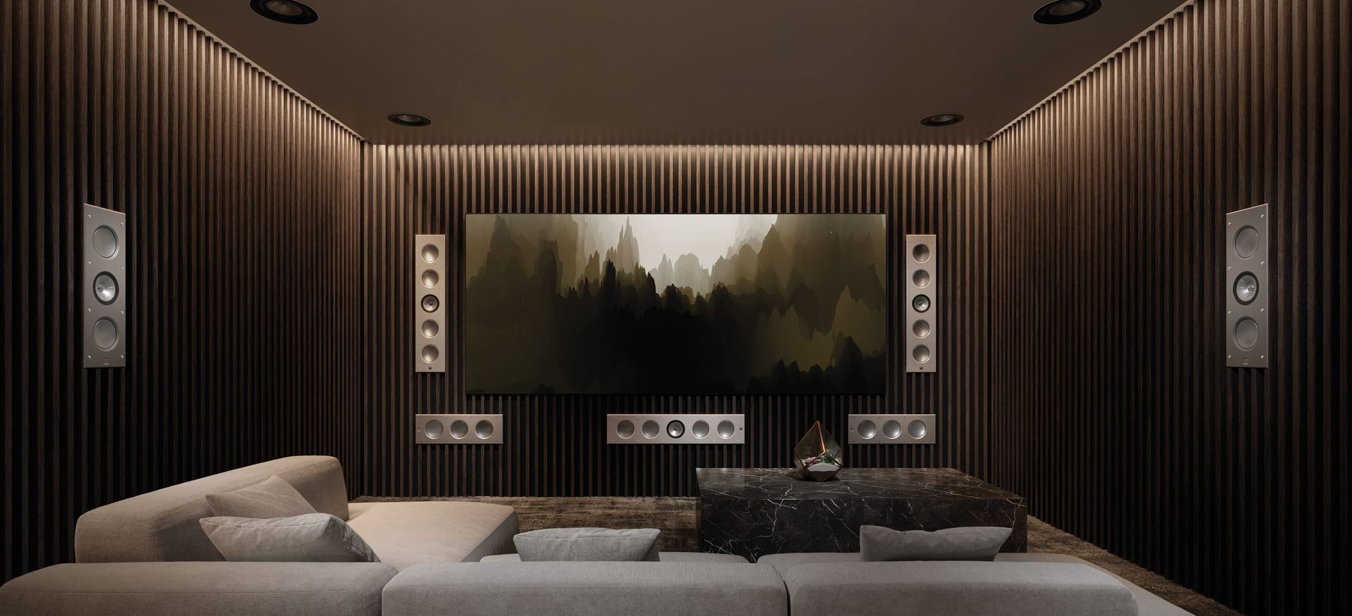 A home theater with a large flat screen tv and a couch.