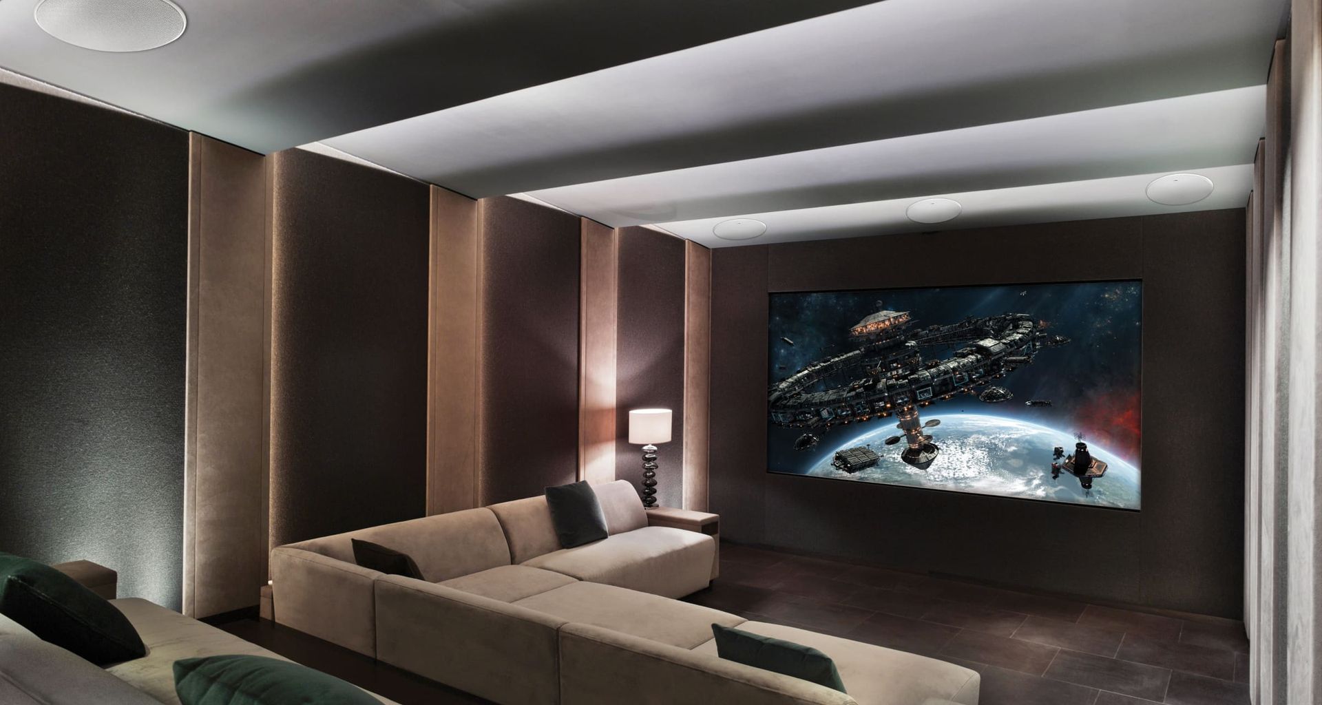 A home theater with a large screen and a couch.