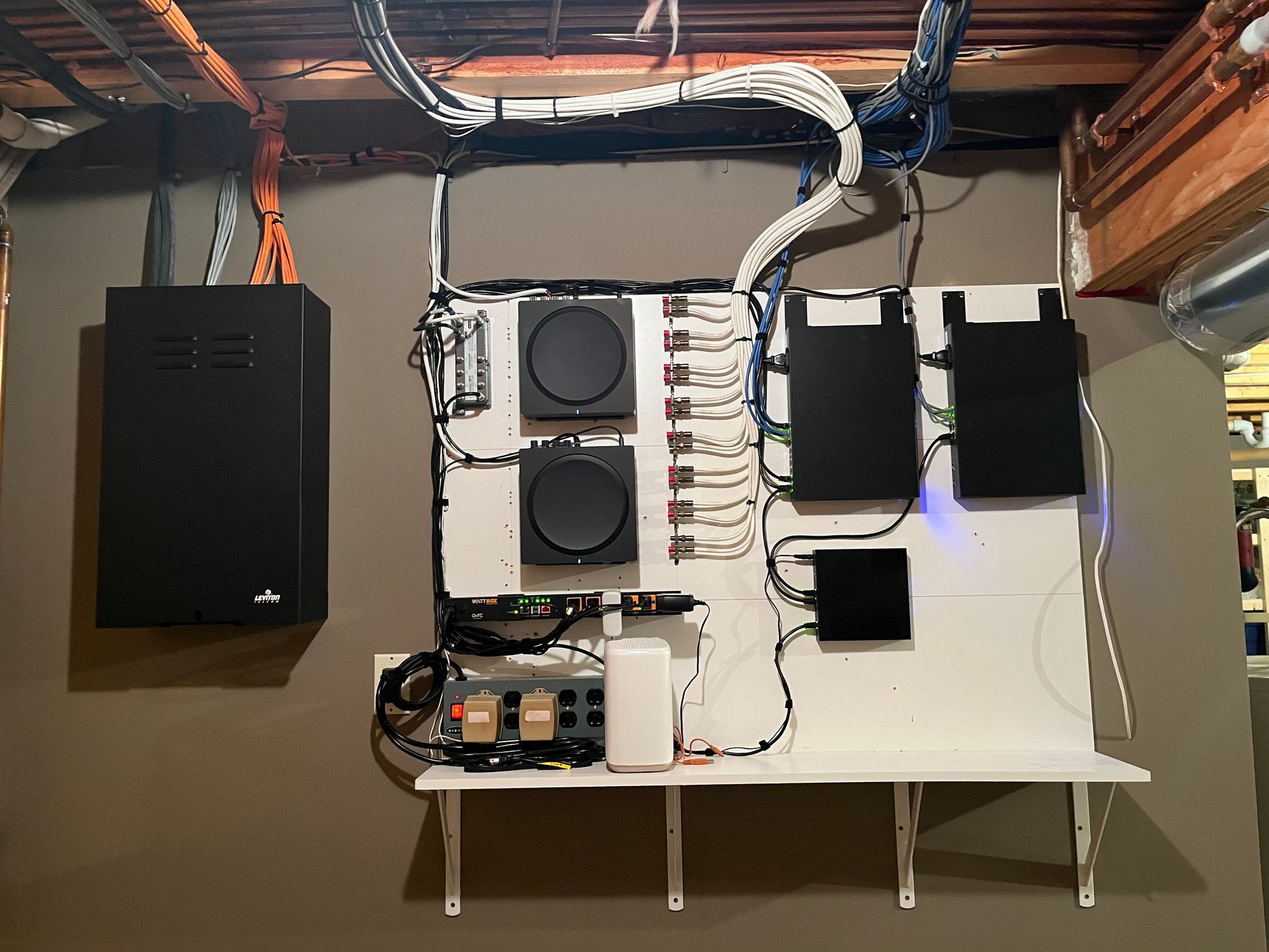 A wall with a lot of wires and speakers on it