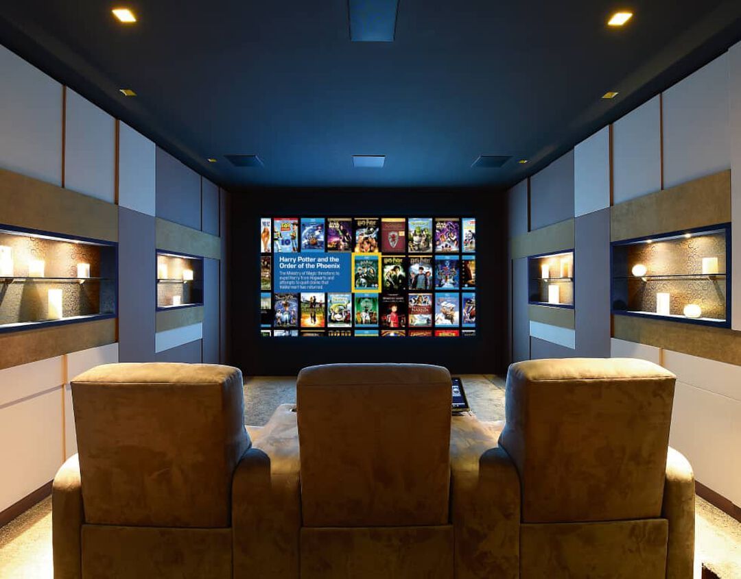 A home theater with a large screen and a lot of pictures on it