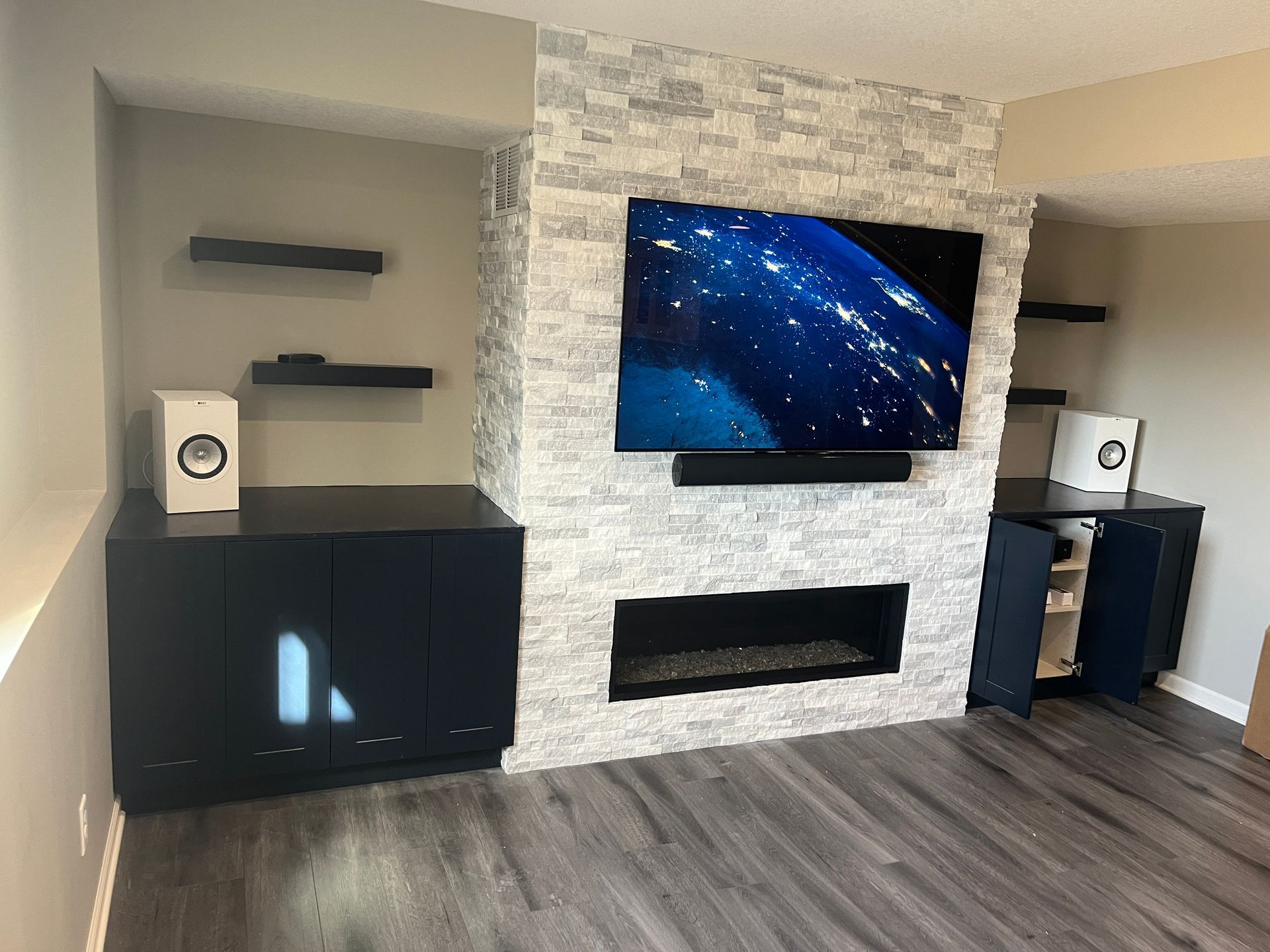 A living room with a fireplace and a flat screen tv.