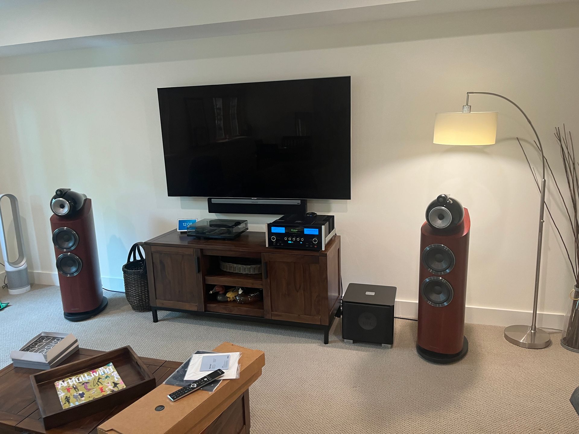 A living room with a flat screen tv and speakers.