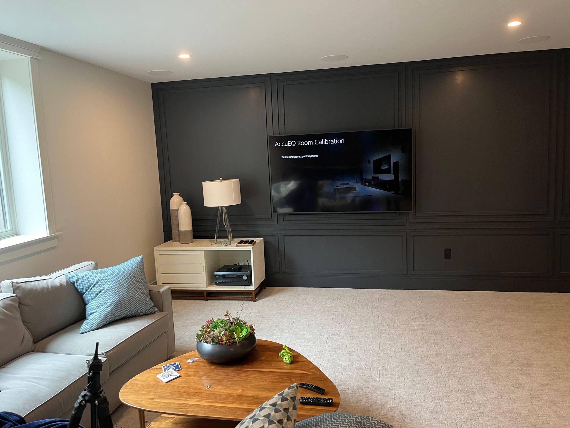 A living room with a couch , table , and television.