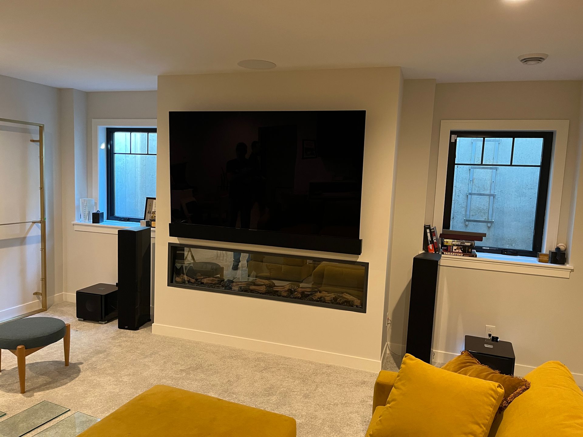 A living room with a large flat screen tv mounted on the wall.