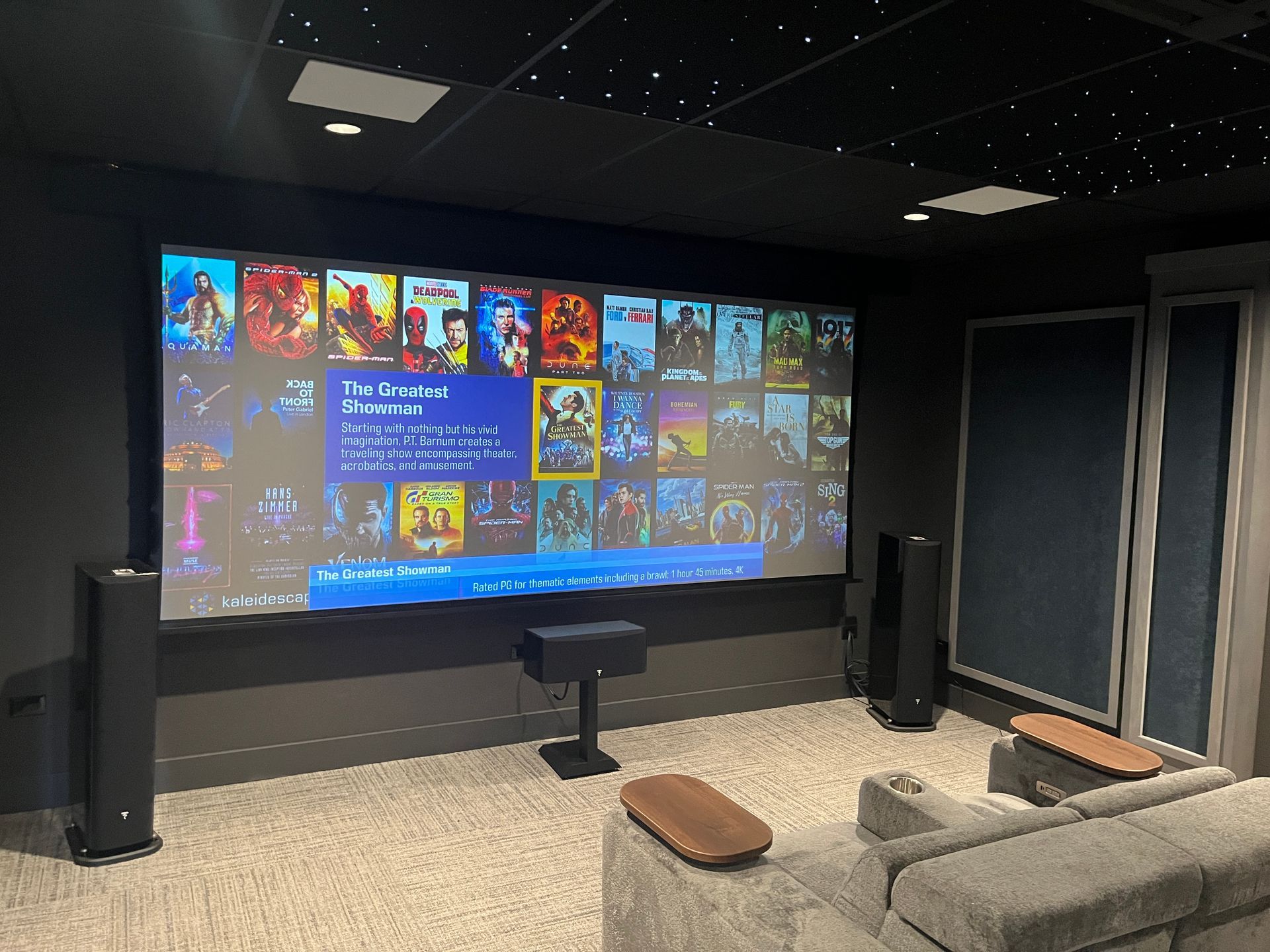 A home theater with a large screen and a couch.